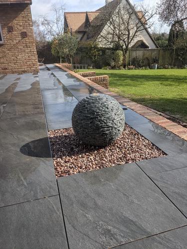500mm Grey Watersphere™ set in a square bed of contrasting pea gravel.